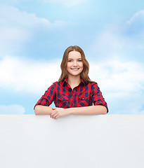 Image showing smiling young teenage girl with white blank board