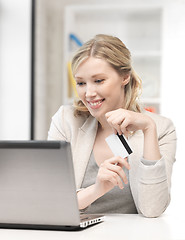 Image showing happy woman with laptop computer and credit card