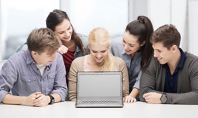 Image showing smiling students looking at blank lapotop screen