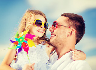 Image showing happy father and child in sunglasses over blue sky