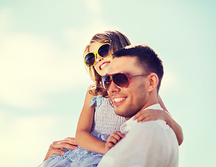 Image showing happy father and child in sunglasses over blue sky