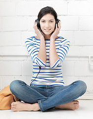 Image showing happy teenage girl in big headphones