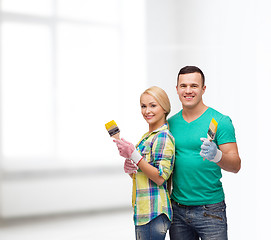 Image showing smiling couple with paintbrush