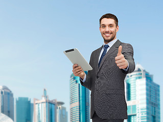 Image showing smiling buisnessman with tablet pc computer