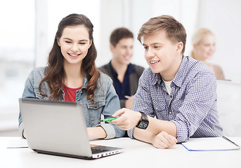 Image showing students with laptop and notebooks at school