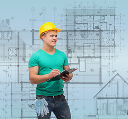 Image showing smiling man in helmet with clipboard