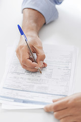 Image showing man signing a contract