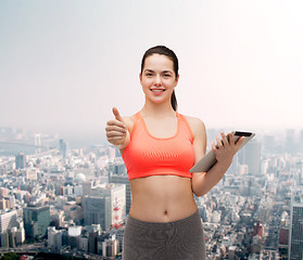 Image showing sporty woman with tablet pc computer