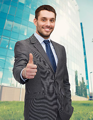 Image showing handsome businessman showing thumbs up