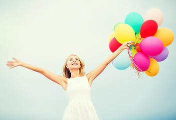 Image showing woman with colorful balloons outside