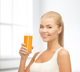 Image showing smiling woman holding glass of orange juice