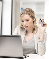 Image showing serious woman with laptop computer and credit card