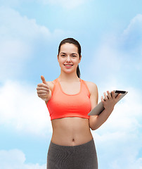 Image showing sporty woman with tablet pc computer