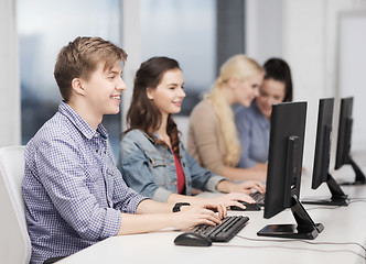 Image showing students looking at computer monitor at school