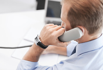 Image showing handsome businessman talking on the phone