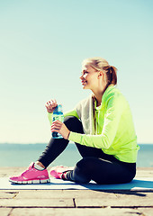 Image showing woman resting after doing sports outdoors