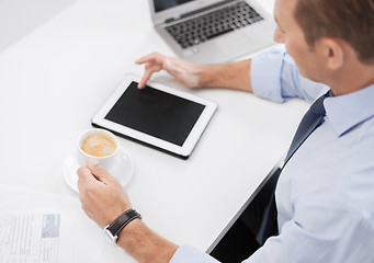 Image showing businessman with tablet pc and coffee in office