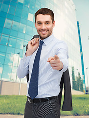 Image showing handsome buisnessman with jacket over shoulder