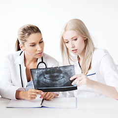 Image showing group of doctors looking at x-ray