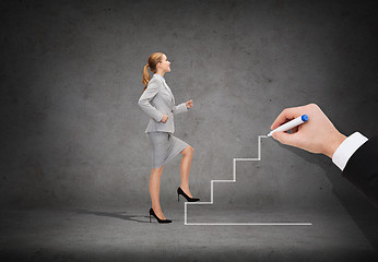 Image showing smiling businesswoman stepping up staircase