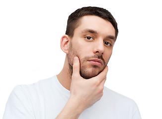 Image showing beautiful calm man touching his face