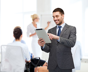 Image showing smiling buisnessman with tablet pc computer