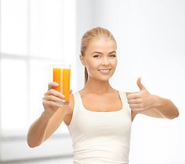 Image showing smiling woman holding glass of orange juice