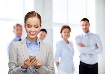 Image showing young smiling businesswoman with smartphone