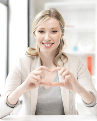 Image showing young woman showing heart sign