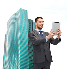 Image showing smiling businessman with tablet pc computer