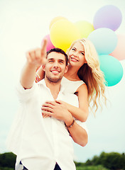 Image showing couple with colorful balloons at sea side
