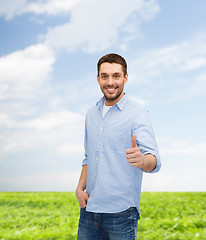 Image showing smiling man showing thumbs up