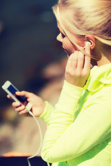 Image showing woman listening to music outdoors