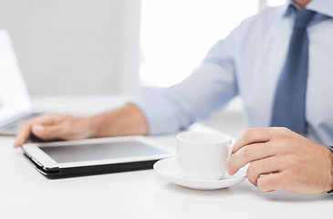 Image showing businessman with tablet pc and coffee in office