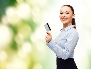 Image showing smiling businesswoman showing credit card