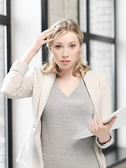 Image showing worried woman with documents