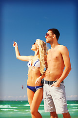 Image showing happy couple in sunglasses on the beach