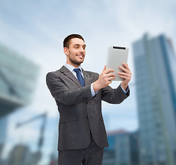 Image showing smiling buisnessman with tablet pc computer