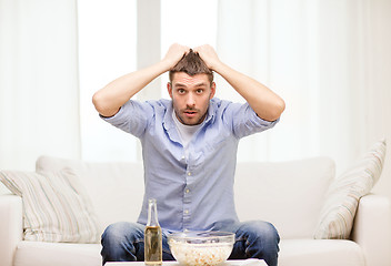 Image showing sad man watching sports at home