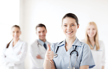 Image showing doctor with group of medics showing thumbs up