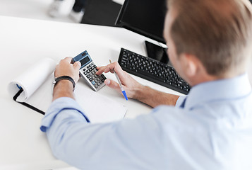 Image showing businessman with notebook and calculator