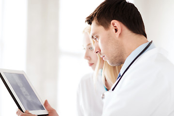 Image showing two doctors looking at x-ray on tablet pc