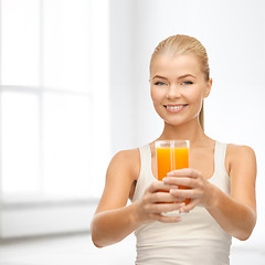 Image showing smiling woman holding glass of orange juice