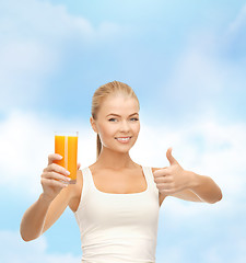 Image showing smiling woman holding glass of orange juice