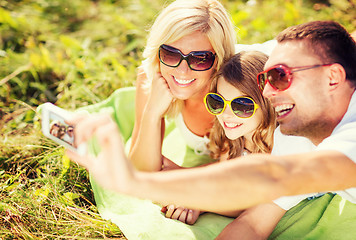 Image showing happy family with camera taking picture