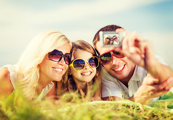 Image showing happy family with camera taking picture