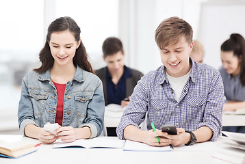 Image showing students looking into smartphone at school
