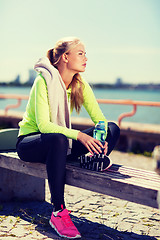 Image showing woman resting after doing sports outdoors