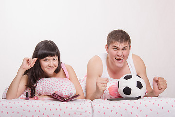 Image showing Man watches football fanatic wife goes crazy already