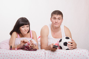 Image showing Man watching soccer on TV, manicure girl engaged in bed